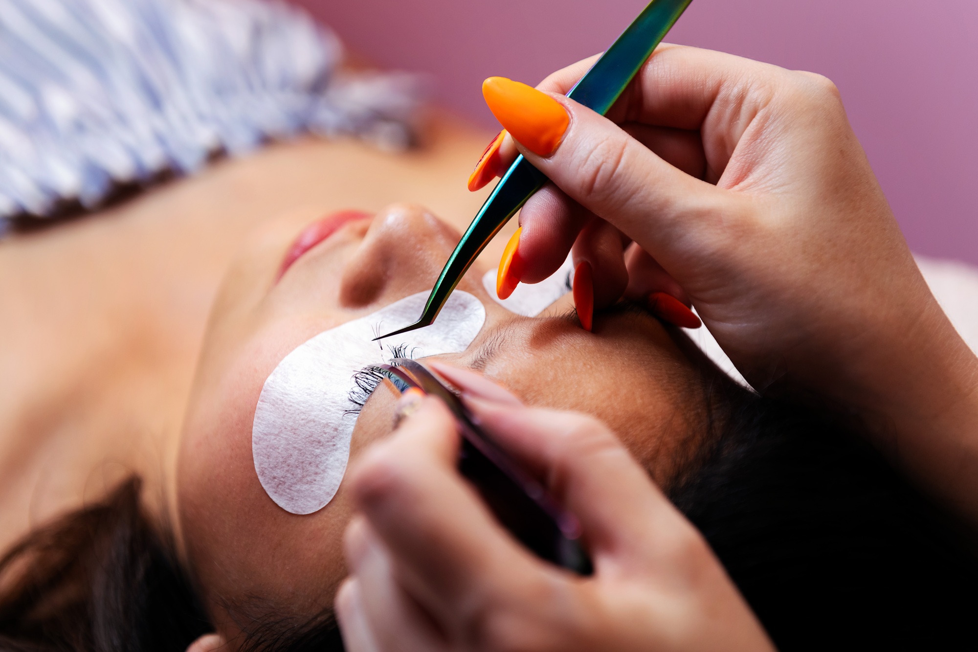 application of false eyelashes with tweezers